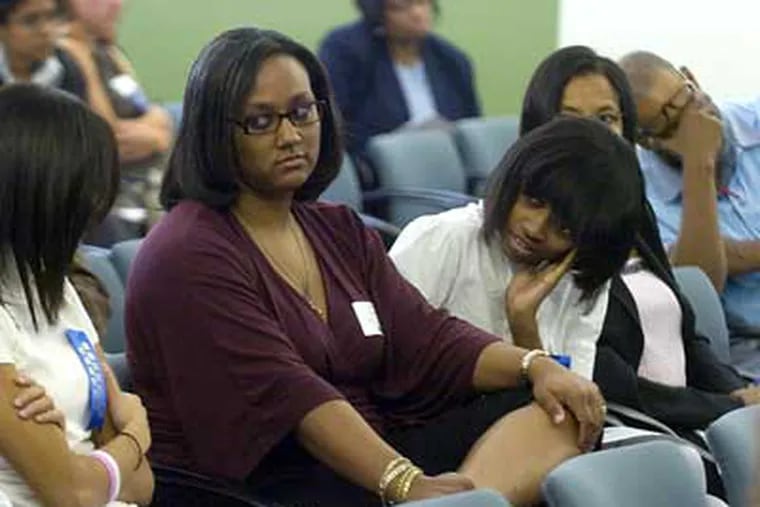 Renaissance Charter School's chief academic officer Alanna Walls (second from left) reacts as she looks to teacher Christine Ishak (arms folded) after the School Reform Commission denied the school's request for a renewal to its charter on Wednesday. (Photo by Clem Murray / Staff Photographer)