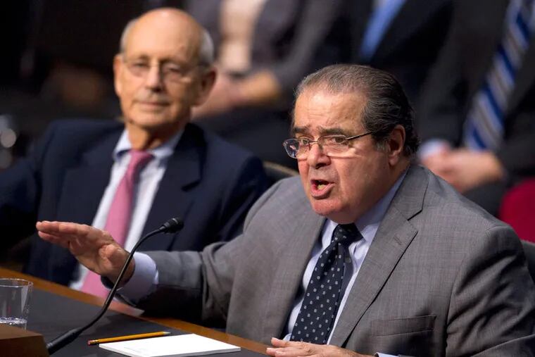 Justice Antonin Scalia testifying at a Capitol Hill hearing in 2011 as Justice Stephen Breyer looks on. Scalia's body is expected back home from Texas this week.