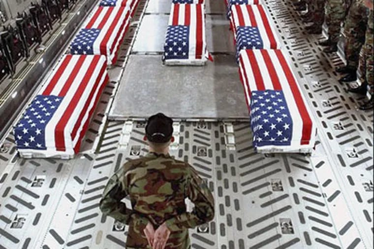 Undated photo by U.S. Department of Defense shows flag-draped coffins of U.S. war casualties aboard a cargo plane in Dover, Del. (AP Photo / Department of Defense)