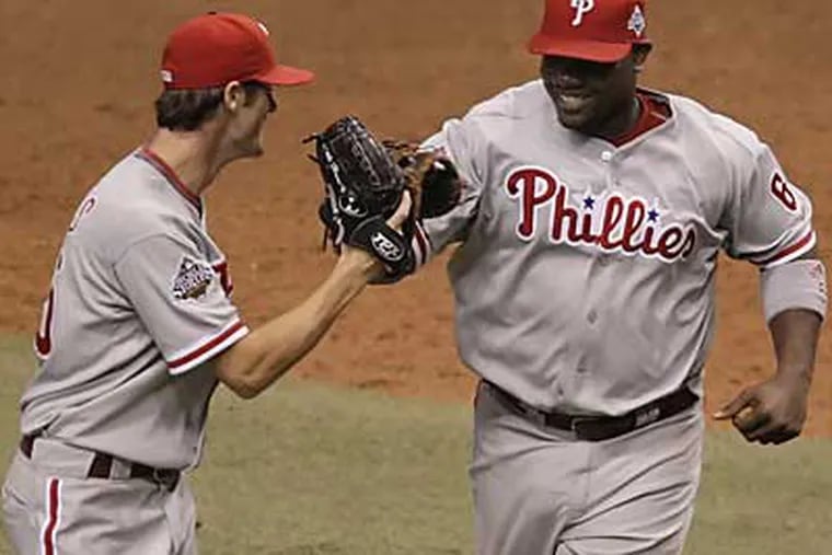 Cole Hamels, left, and Ryan Howard walk off the field in the seventh inning of the Phillies' 3-2 win over the Rays in Game 1 of the World Series. (David Maialetti / Staff Photographer)