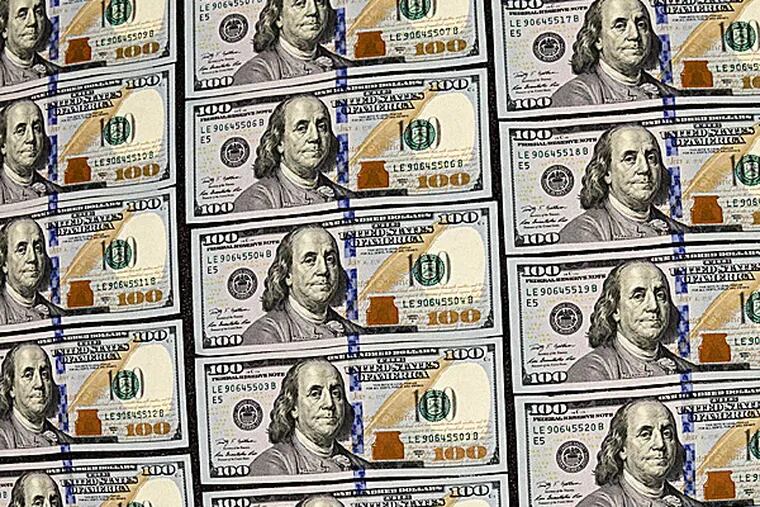 U.S. currency in one hundred dollar denominations. (J. Scott Applewhite/AP)