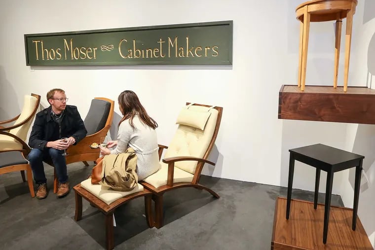 Eric Heidel and Sary Em relax during the opening of the Maine-based high-end furniture maker Thos. Moser at its new 1605 Walnut Street Showroom, Thursday, November 10, 2016.