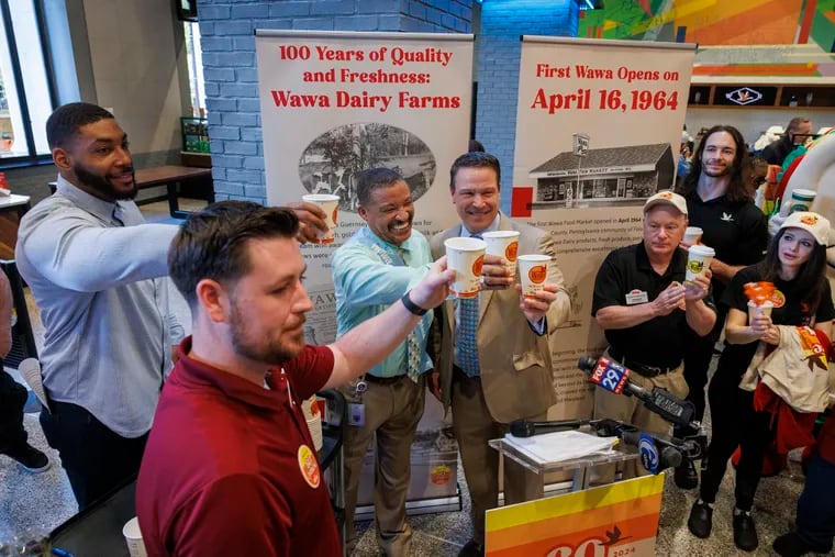 From left are James Toner, General Manager of Wawa's flagship store; Devon Still, former NFL player; Tony Stephens, the 'Day Brightener' customer from the flagship store; and Wawa president Brian Schaller during the ceremonial first coffee pour at the Wawa Day festivities at the flagship store in Center City Tuesday.