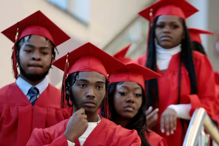 Graduates including Kaiyon Jaynes (front) listen to instructions from administrators prior to the 2022-2023 mid-year high school commencement ceremony at the School of the Future in Phila., Pa. on Wed., Feb. 08, 2023.