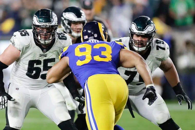 Eagles offensive tackle Lane Johnson and offensive guard Brandon Brooks watch Los Angeles Rams nose tackle Ndamukong Suh during the third-quarter on Sunday, December 16, 2018 in Los Angeles.  YONG KIM / Staff Photographer