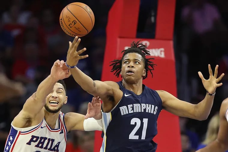 Ben Simmons (left) of the 76ers and the Grizzlies’ Deyonta Davis go after a long rebound.