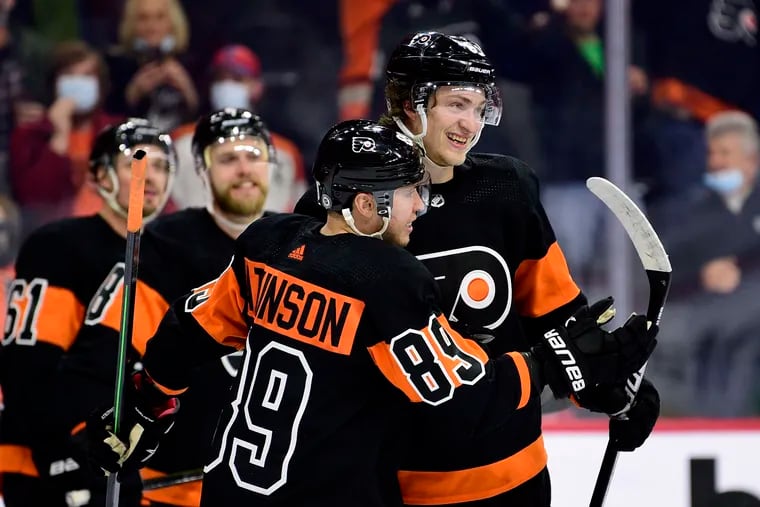 The Flyers' Travis Sanheim (right) celebrates with Cam Atkinson (89) after a victory in overtime against the Ottawa Senators last month.