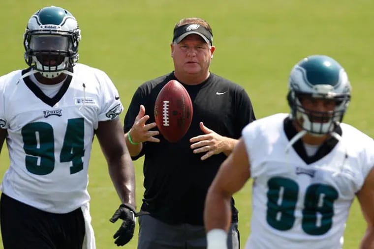 Chip Kelly in between Chris McCoy and Connor Barwin. (David Maialetti/Staff Photographer)