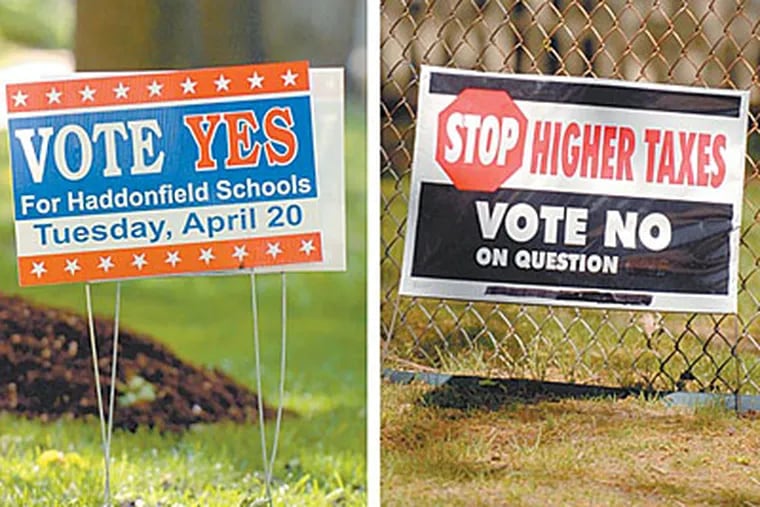 Signs on both sides of the budget question are in front lawns in  Haddonfield (left) and Collingswood (right). ( Tom Gralish / Staff Photographer )