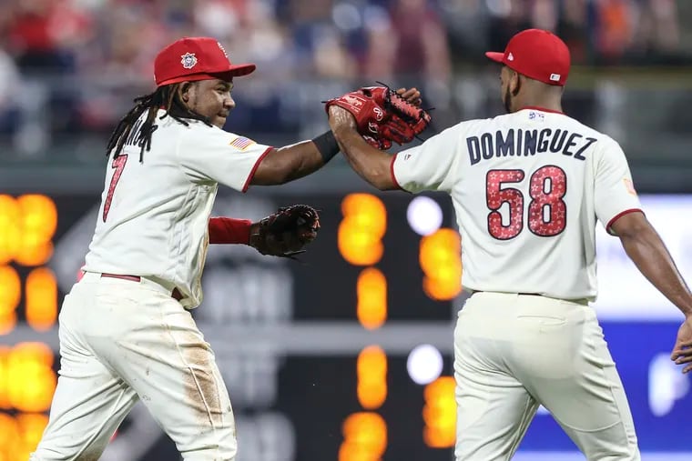 Phillies third baseman Maikel Franco celebrates with reliever Seranthony Dominguez after his game-saving play in the bottom of the eighth inning against the Orioles on Tuesday.