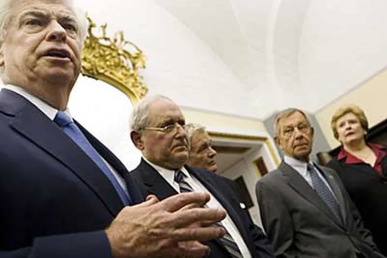 Sen. Christopher Dodd, D-Conn., Chairman of the Senate Committee on Banking, Housing and Urban Affairs, left, with other members of Congress after the Senate's rejection of an automaker bailout proposal. (APi)