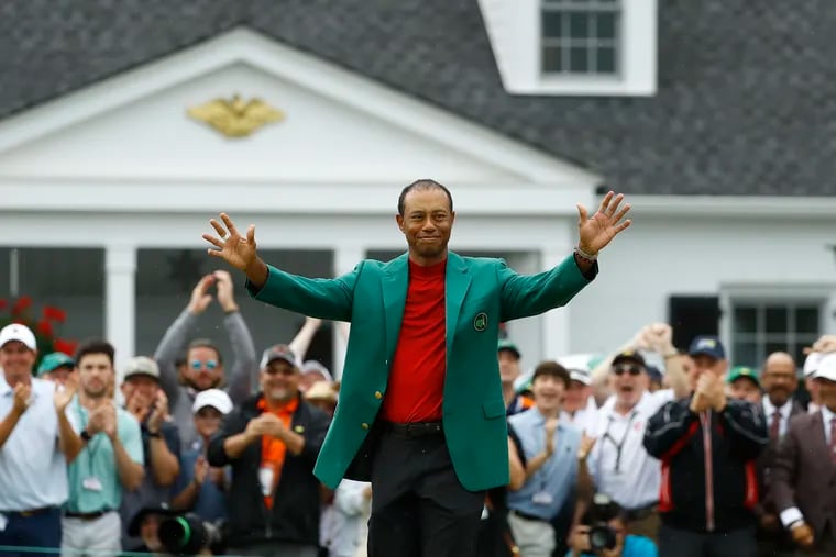 Tiger Woods smiles as he wears his green jacket after winning the Masters. A local sportsbook quickly put out odds on whether he'll break Jack Nicklaus' record for career major victories.