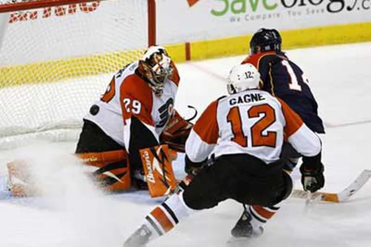 Florida Panthers right wing Radek Dvorak, upper right, scores against Philadelphia Flyers goalie Ray Emery in the Flyers' 4-2 loss to the Panthers. (AP Photo/ Wilfredo Lee)