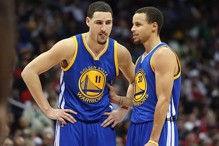 Golden State Warriors guard Klay Thompson (11) and guard Stephen Curry (30) talk in the third quarter of their game against the Atlanta Hawks at Philips Arena. The Hawks won 124-116. (Jason Getz/USA Today)