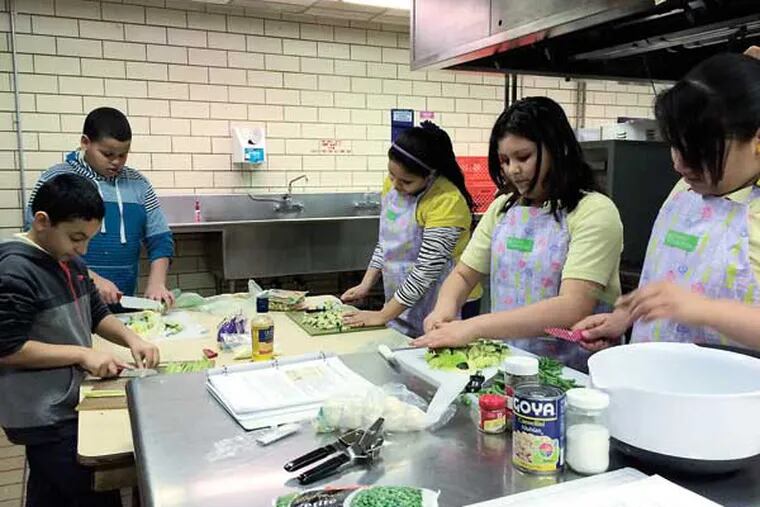 Students (from left) Dave Garcia, Delfri Guzman, Yosanit Bonilla, Yaritza Robles and Chanitza Sanchez prep ingredients for Tortelloni Minestrone Soup. (Photo by Nicole Molino)