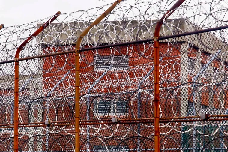 A security fence surrounds inmate housing on the Rikers Island correctional facility in New York. Health experts say prisons and jails are considered a potential epicenter for America’s coronavirus pandemic.