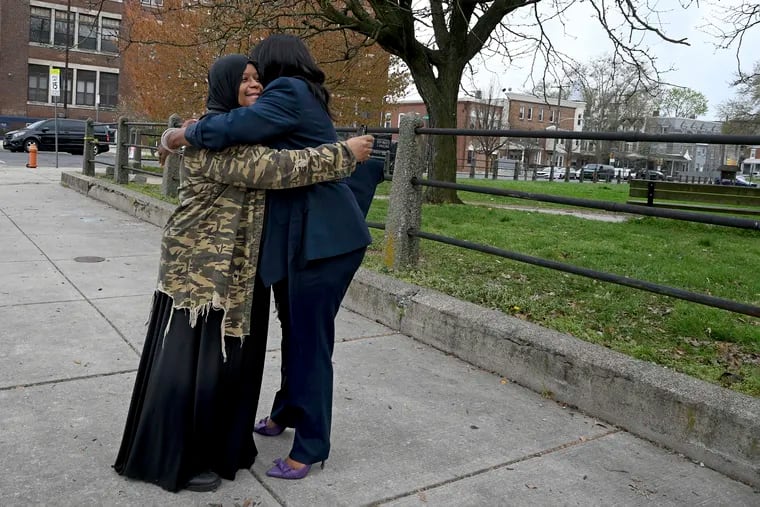 Community activists Mecca Robinson (left) and Sajda ‘Purple’ Blackwell (right) embrace outside Clara Muhammad Square Thursday, April 11, 2024. They had just completed a canvass of the neighborhood with other community leaders the day after a shootout erupted at an Eid al-Fitr celebration there.