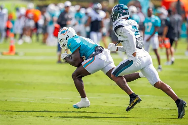Dolphins wide receiver Tyreek Hill runs with the ball against Eagles cornerback Darius Slay during a joint practice on Wednesday in Miami Gardens, Fla.