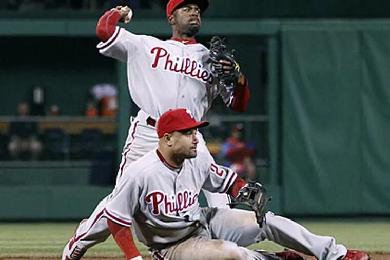Jimmy Rollins could not get the throw to first in time in the 10th inning, allowing a Pirates run to score. (Keith Srakocic/AP)