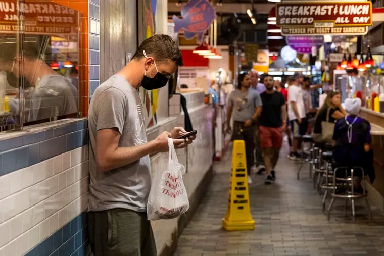 A person on their phone at Reading Terminal Market in Center City on Wednesday.