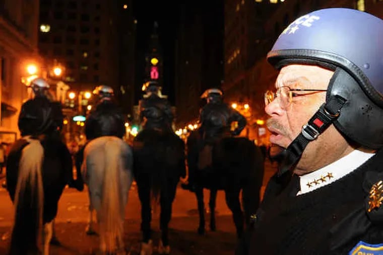 Police Commissioner Charles H. Ramsey and a line of mounted police keep the peace during postgame celebrations in Center City.
