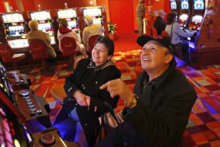 Sergio Gonzalez (right) and wife, Myrian Otero Gonzalez (left) of Philadelphia, react to his win at PhiladelphiaPark Casino. The Pa. casinos have contributed to the troubles at A.C. casinos. (Michael S. Wirtz/ Staff Photographer)