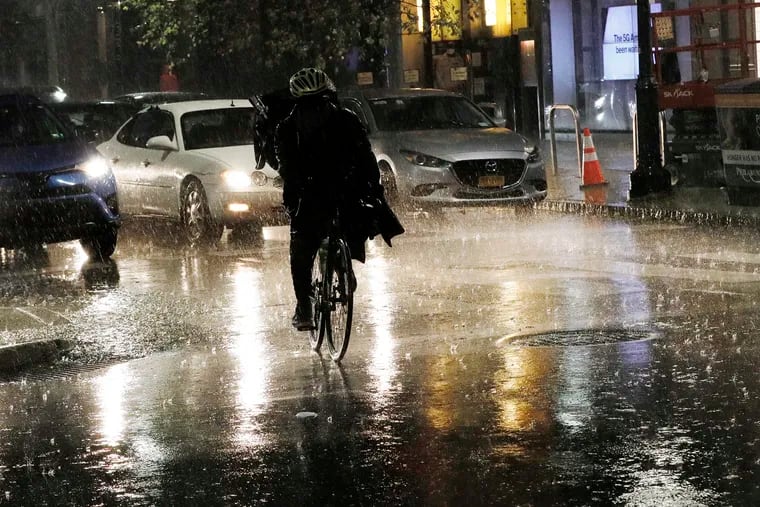 A bicyclist maneuvers on 15th and Walnut streets. Showers are likely Monday night.