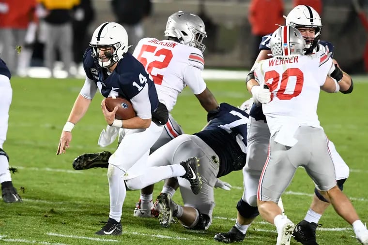 Penn State quarterback Sean Clifford (14) scrambles during  the loss to  Ohio State on Saturday night.