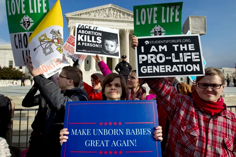 FILE - In this Jan. 18, 2019, file photo, anti-abortion activists protest outside of the U.S. Supreme Court, during the March for Life in Washington. The number and rate of abortions across the United States have plunged to their lowest levels since the procedure became legal nationwide in 1973, according to new figures released Wednesday, Sept. 18.  (AP Photo/Jose Luis Magana, File)
