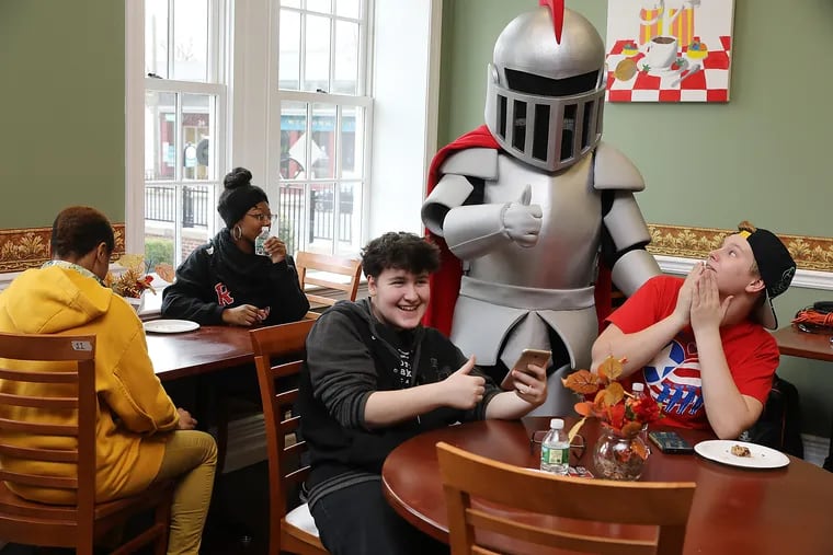 Barry the Baron, the new mascot of Rowan College at Burlington County, NJ, meets  students (from left) Kaylee Brewster, Au'Set  Wright, Aleks Velesbir, and Ryan Wenzler in the cafeteria of the Mount Holly campus. Students said they like Gritty,  the Flyers' famous new mascot — but like  Barry too.