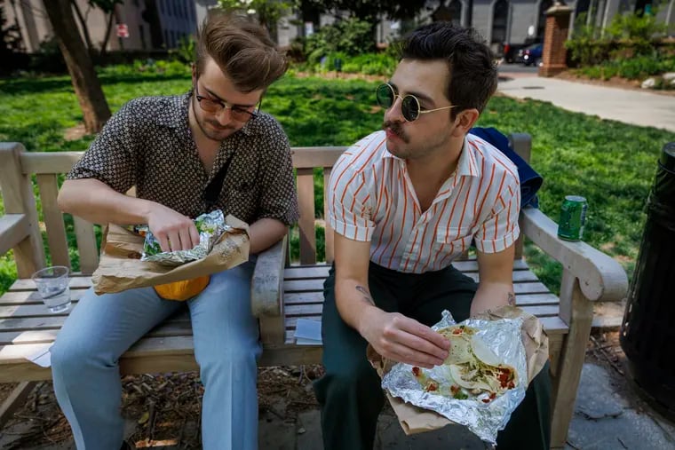 Architects Thomas Keller and Henri Brooks (right) eat tacos from  El Fuego in Washington Square Park. I eat Mexican twice a week, Keller said.
