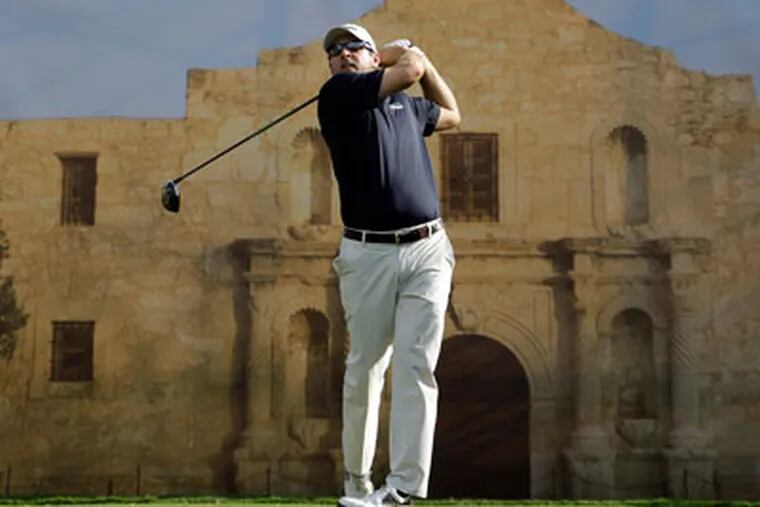 Ben Curtis watches his tee shot from the 18th hole during the first
round of the Texas Open golf tournament on Thursday, April 19, 2012,
in San Antonio. A mural-sized photo of the Alamo hangs in the
background. (AP Photo/Eric Gay)