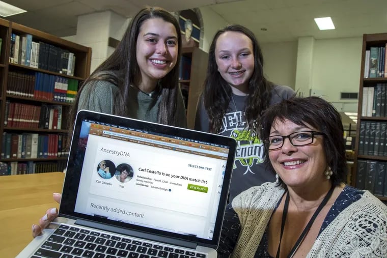 Upper Darby High School teacher Sue Beck, who was given up for adoption at birth 57-years-ago, holds a laptop computer showing her ancestry.com page and how she matches with her father Carl Costello as the two students sleuths Ñ Gabriella Vizzarri (left) and Rylee Shanahan Ñ who helped her find her family look on in the school library December 5, 2017. CLEM MURRAY / Staff Photographer