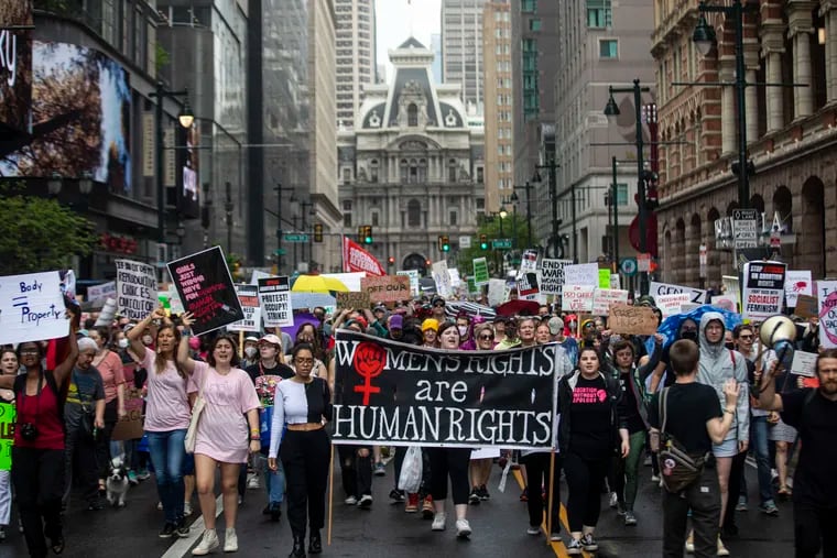 Many gather and march the streets of Center City for the City Women’s March rally along East Market Street in Philadelphia, on Saturday. The rally was part of a nationwide protest against the potential overturning of Roe v Wade.