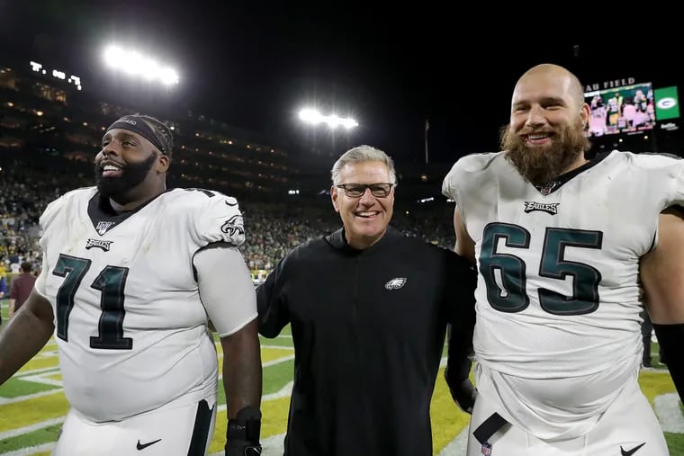 Offensive line coach Jeff Stoutland (center) still has Lane Johnson (right) to smile about, but Jason Peters (left) is now a free agent.