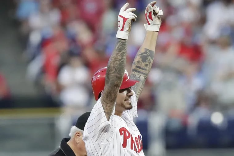 Phillies pitcher Vince Velasquez raises his arms after hitting a third-inning double against the Miami Marlins on Friday, August 3, 2018 in Philadelphia.