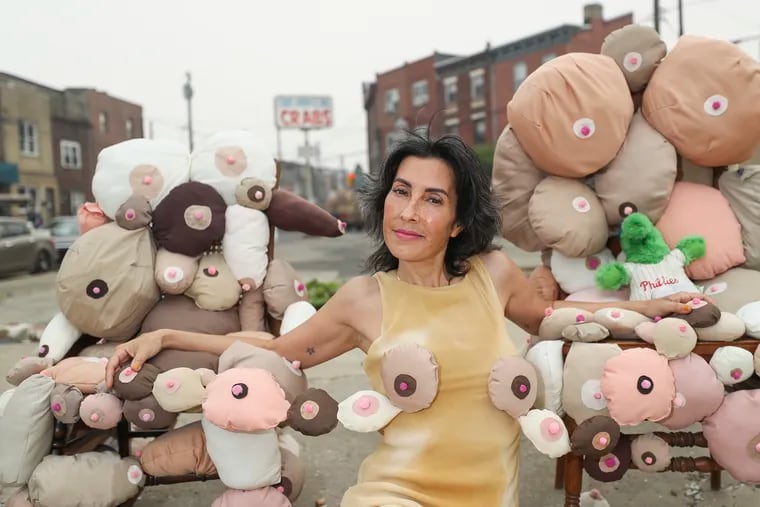 Rose Luardo with her pop-up exhibit of breast plushies at the vacant lot where Capt. Jesse G's Crab Shack once stood, on Washington Avenue between Eighth and Passyunk, in Philadelphia.