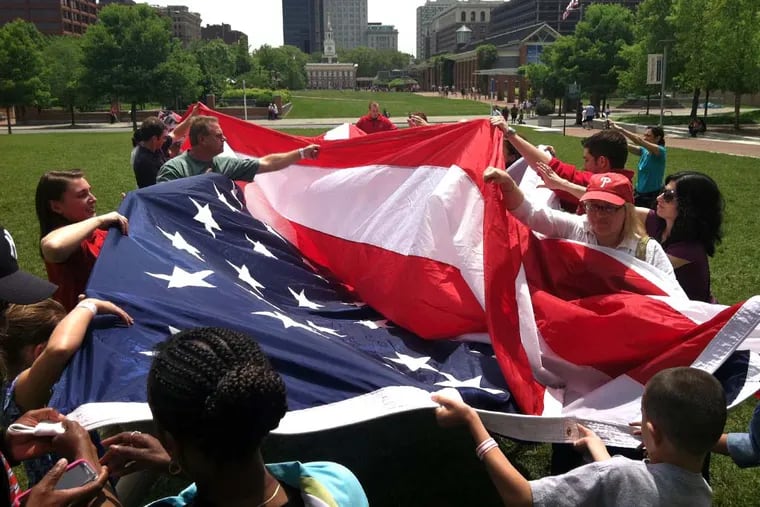 Tourists learned the ins and outs of flag etiquette, including how to properly fold the flag, on Independence Mall a few years ago