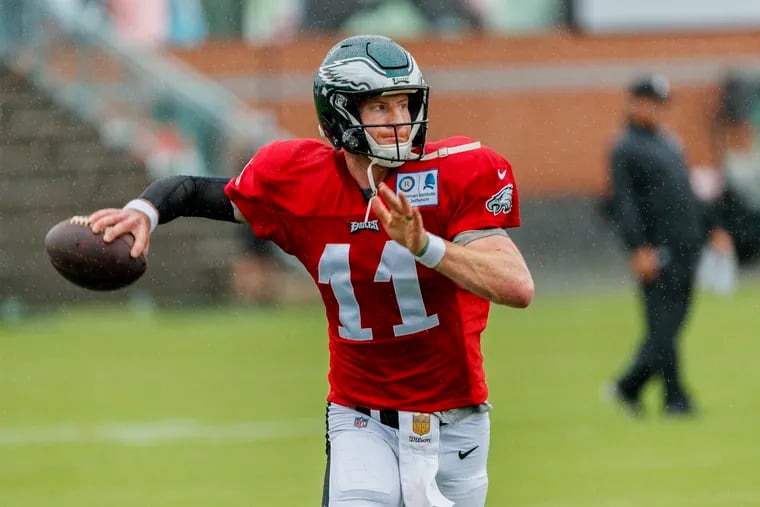 Eagle quarterback Carson Wentz rolls out to throw, in the rain, during the Eagles practice session on Sunday, August 19, 2018, at the NovaCare Center. MICHAEL BRYANT / Staff Photographer