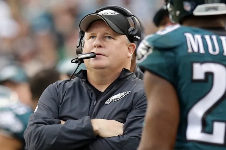 Eagles Head Coach Chip Kelly look up at a replay next to DeMarco Murray against the Buffalo Bills on Sunday, December 13, 2015 in Philadelphia.