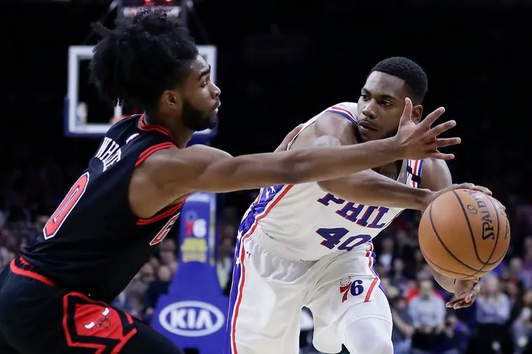 Sixers forward Glenn Robinson III passes the basketball past Chicago Bulls guard Coby White during the second-quarter action on Sunday.