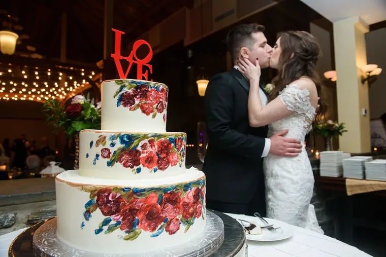 Eric Most and Rachel McLaughlin share a kiss right after they cut their wedding cake at their reception at Knowlton Mansion.