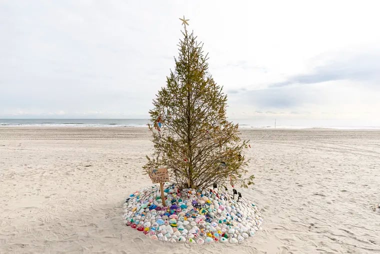 A Christmas tree put up by Sue McElwee, of Ocean City, N.J. Beach Christmas trees have proliferated in Jersey Shore towns, most lit with solar lights and often with their own themes.