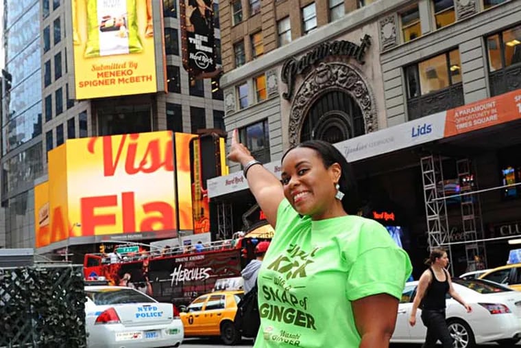 Meneko Spigner McBeth, of Deptford, New Jersey, who submitted Wasabi Ginger, sees her potato chip flavor revealed on a billboard high above Times Square on Wednesday, July16, 2014, in New York. Photo by Diane Bondareff
