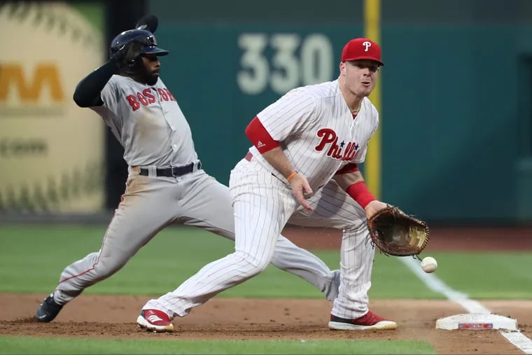 A pickoff throw by catcher Wilson Ramos get by 1st baseman Justin Bour, right, of the Phillies allowing Jackie Bradley, Jr. of the the Red Sox to advance to 3rd in the 2nd inning at Citizens Bank Park on August 15, 2018.