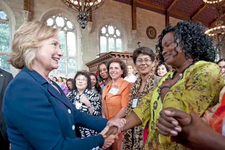 At Bryn Mawr College, Hillary Clinton speaks at an international women's conference on July 9, 2013.   Here, she shakes the hand of Marayah LWM Fineah of Liberia.  ( APRIL SAUL / Staff )