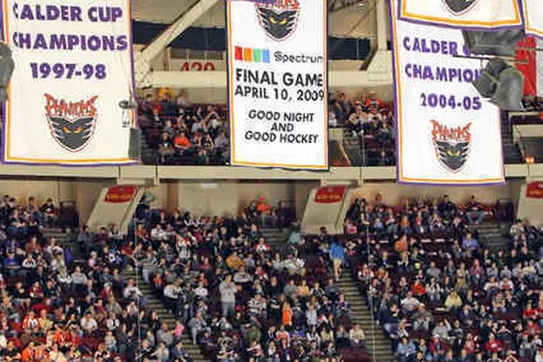 Sellout crowd watches Phantoms play final regular-season game at Wachovia Spectrum. A final game banner was unveiled before the game. Phantoms' Rob Sirianni celebrates goal with fan.
