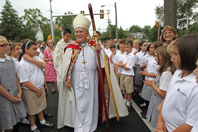 Archbishop Charles Chaput, center, walks through a swarm of children and family members on the first day of schoo at mater Dei in Lansdale, PA.   With the reconfigured Archdiocese schools starting up this week, the Archbishop will lead a blessing at the newly merged Mater Dei in Lansdale.  Archbishop Charles Chaput, O.F.M., Cap. will lead a prayer service and bless the newly merged "regional school." Classes started Wednesday, and after the blessing students will return to their classrooms.