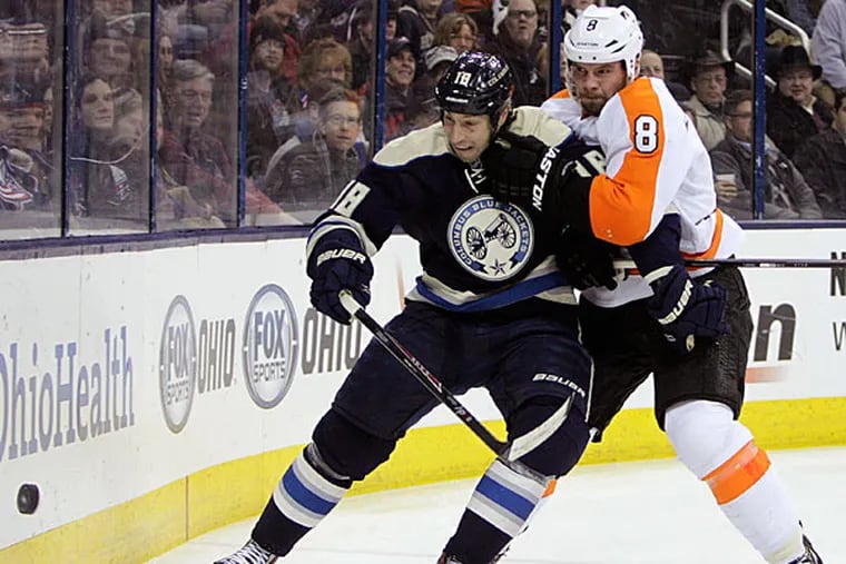 The Flyers' Nicklas Grossman, right, of Sweden, and Columbus Blue Jackets' RJ Umberger fight for a loose puck during the second period of an NHL hockey game Thursday, Jan. 23, 2014, in Columbus, Ohio. (Jay LaPrete/AP)