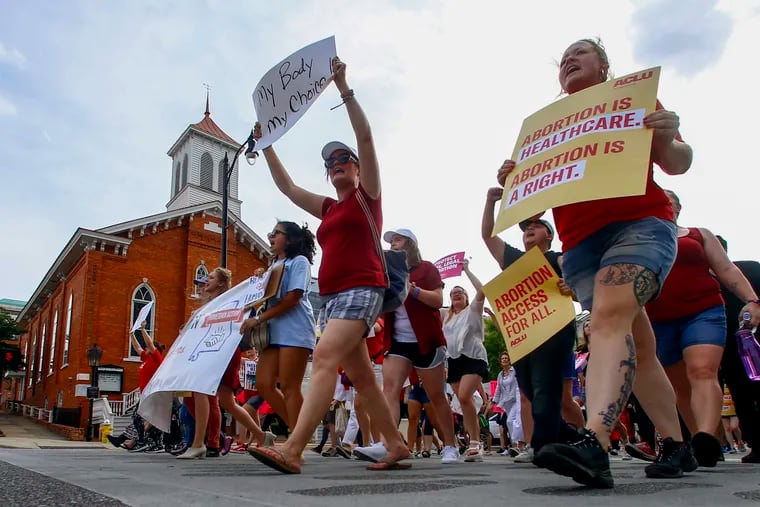 Protesters for women's rights march past Dexter Avenue Baptist Church to the Alabama Capitol to protest a law passed last week making abortion a felony in nearly all cases with no exceptions for cases of rape or incest, Sunday, May 19, 2019, in Montgomery, Ala.